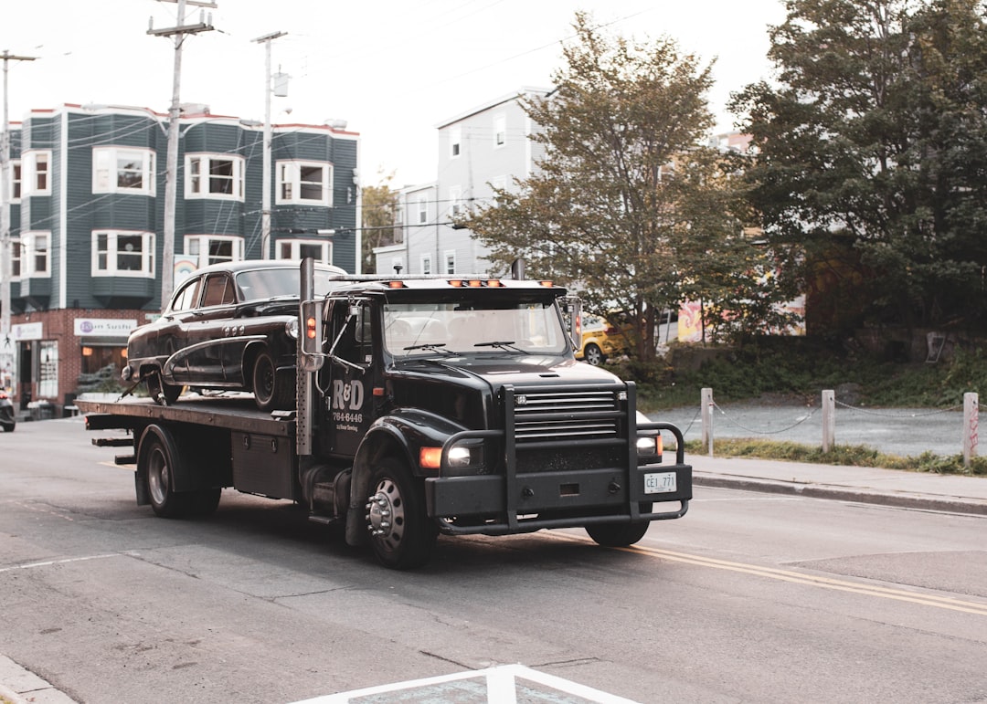 black-truck-on-road-during-daytime-uxovudfkhuy